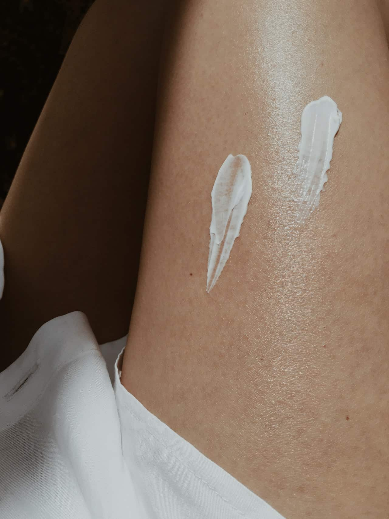 jolie peau : crème solaire sur la jambe